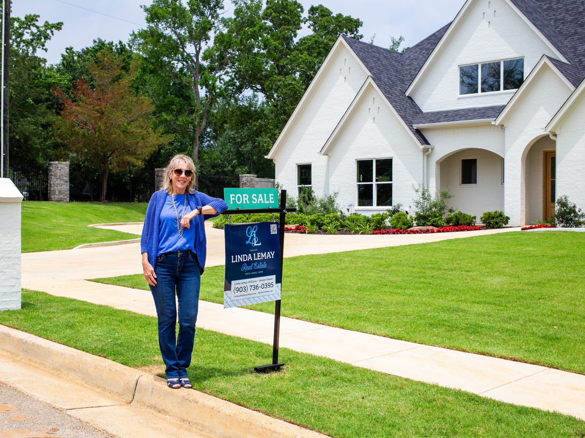 Wide exterior of a Nicholas Humphrey custom home with steep gables and mature landscaping.