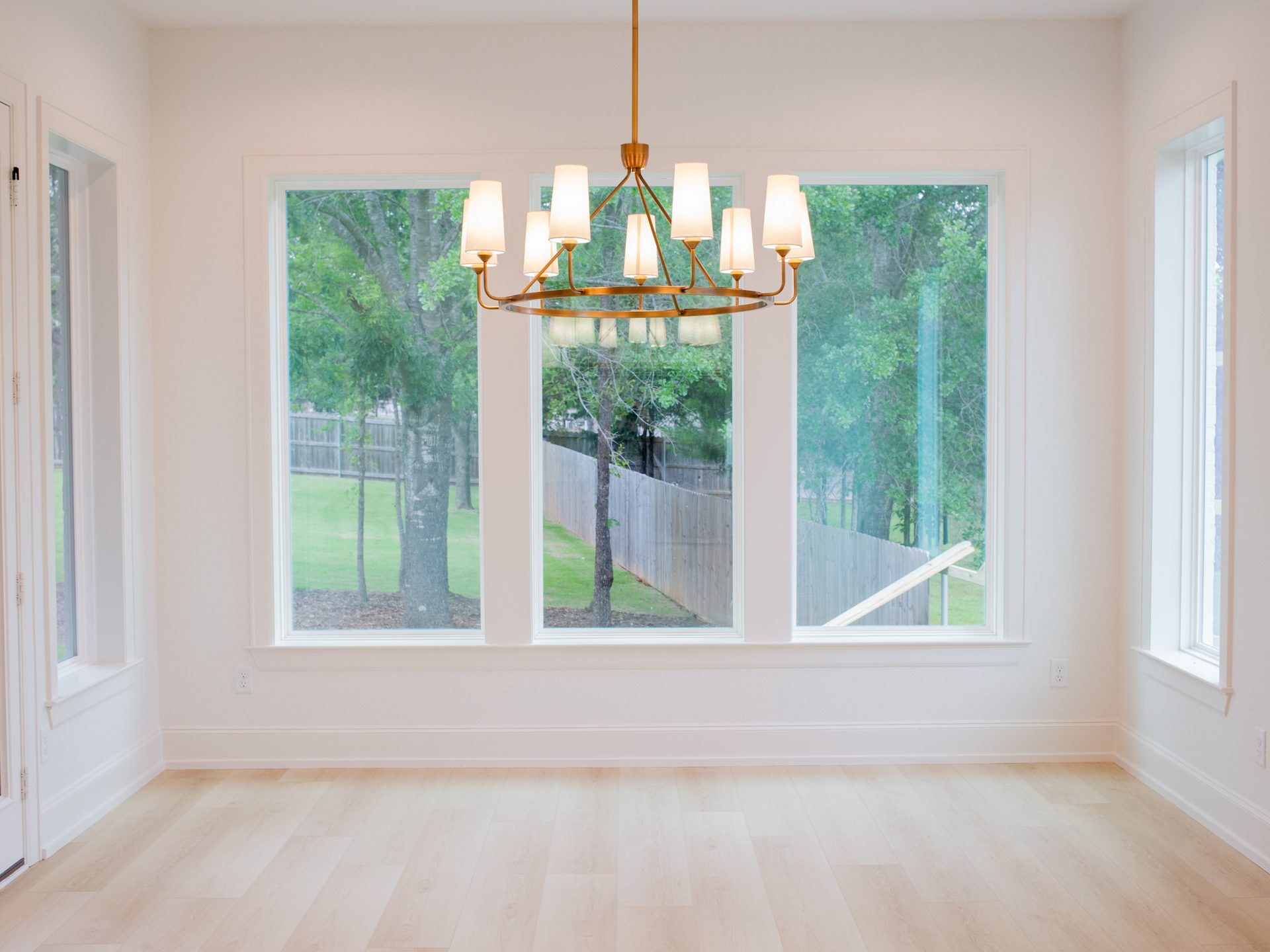 Formal dining room with crystal chandelier and wainscoting.