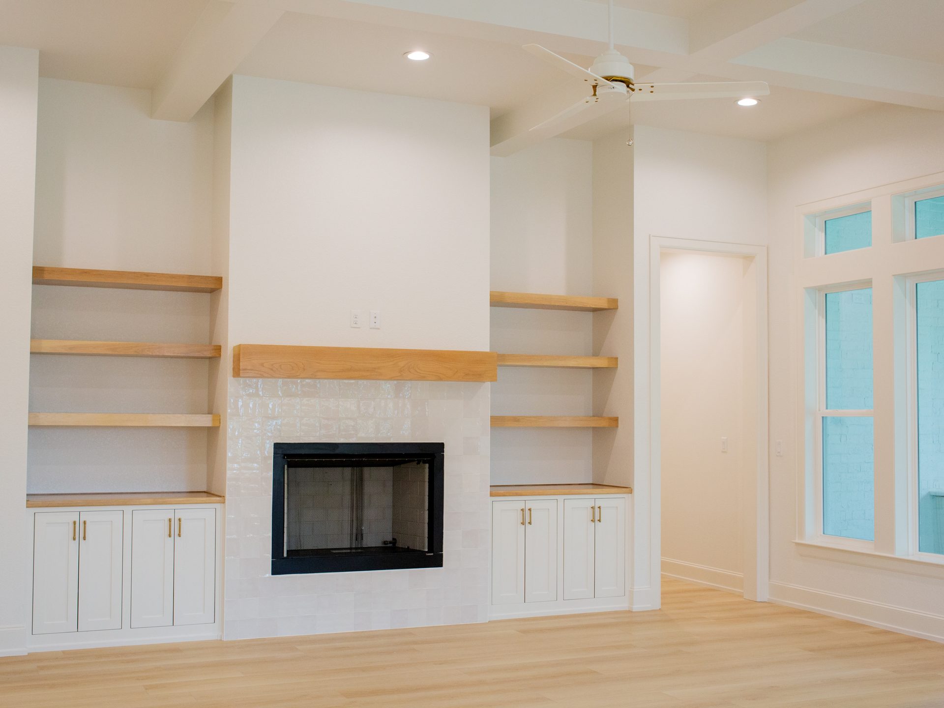 Custom kitchen with natural wood cabinetry and marble island.